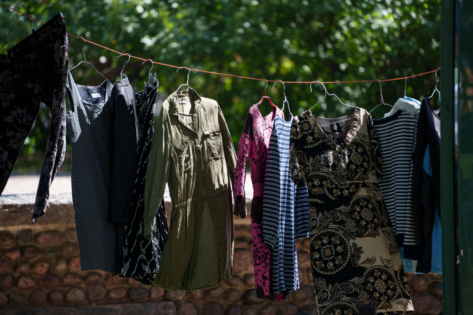 Tamron 50-300mm F4.5-6.3 Di III VC VXD sample photo. Fleamarket clothing rack photography