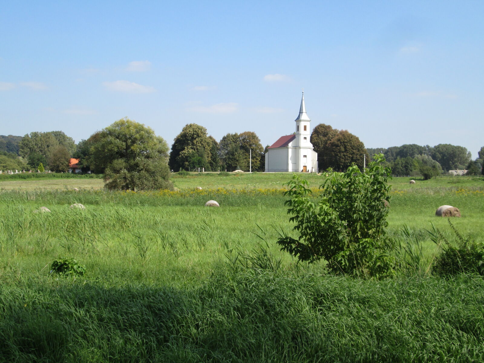 Canon PowerShot A1300 sample photo. Church, countryside, hay, bale photography