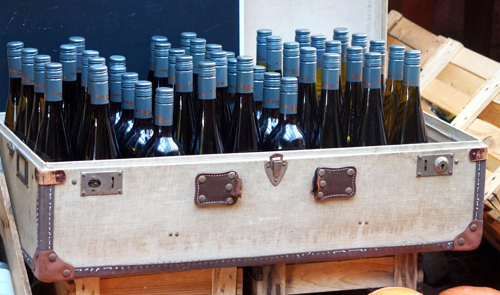 Sony Alpha a5000 (ILCE 5000) + Sony E 55-210mm F4.5-6.3 OSS sample photo. Wine, bottles, luggage photography
