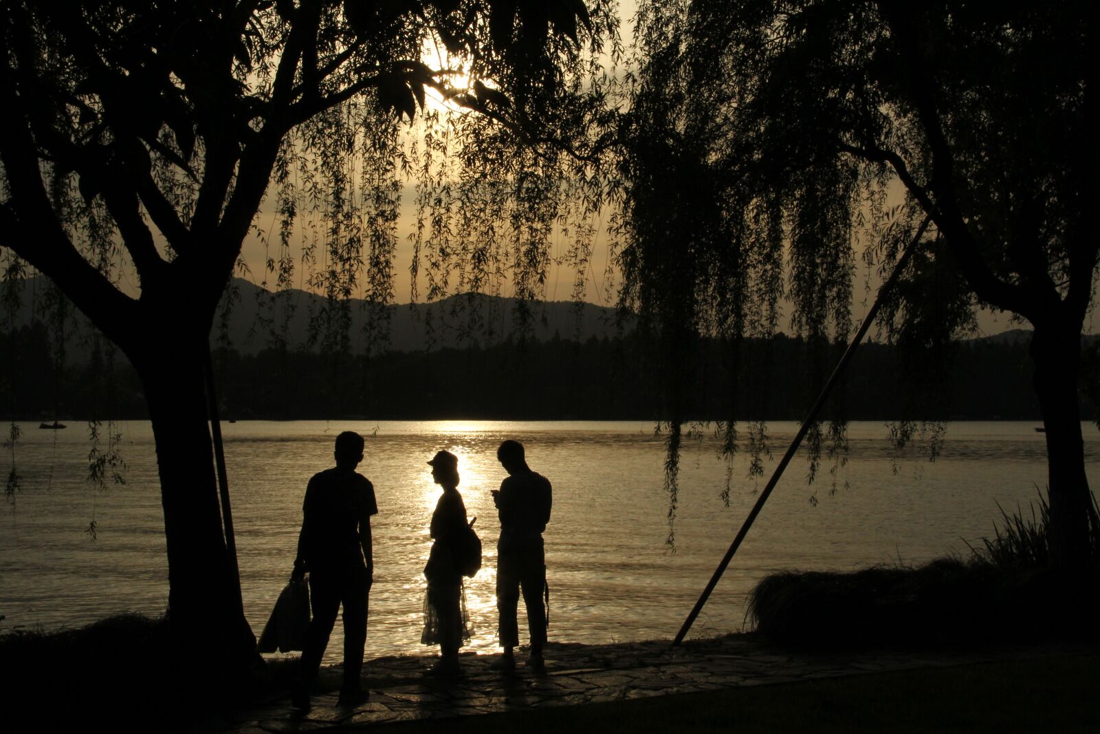 Canon EF-S 18-135mm F3.5-5.6 IS sample photo. West lake, pedestrian, sunset photography