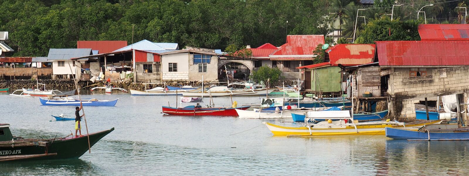 OLYMPUS M.14-150mm F4.0-5.6 II sample photo. Boats, stilt houses, river photography