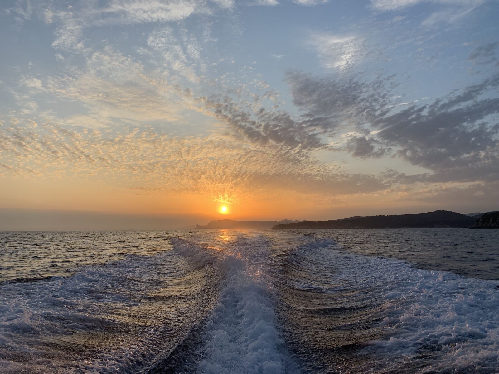 Apple iPhone XR sample photo. Waves, sunset, boat photography