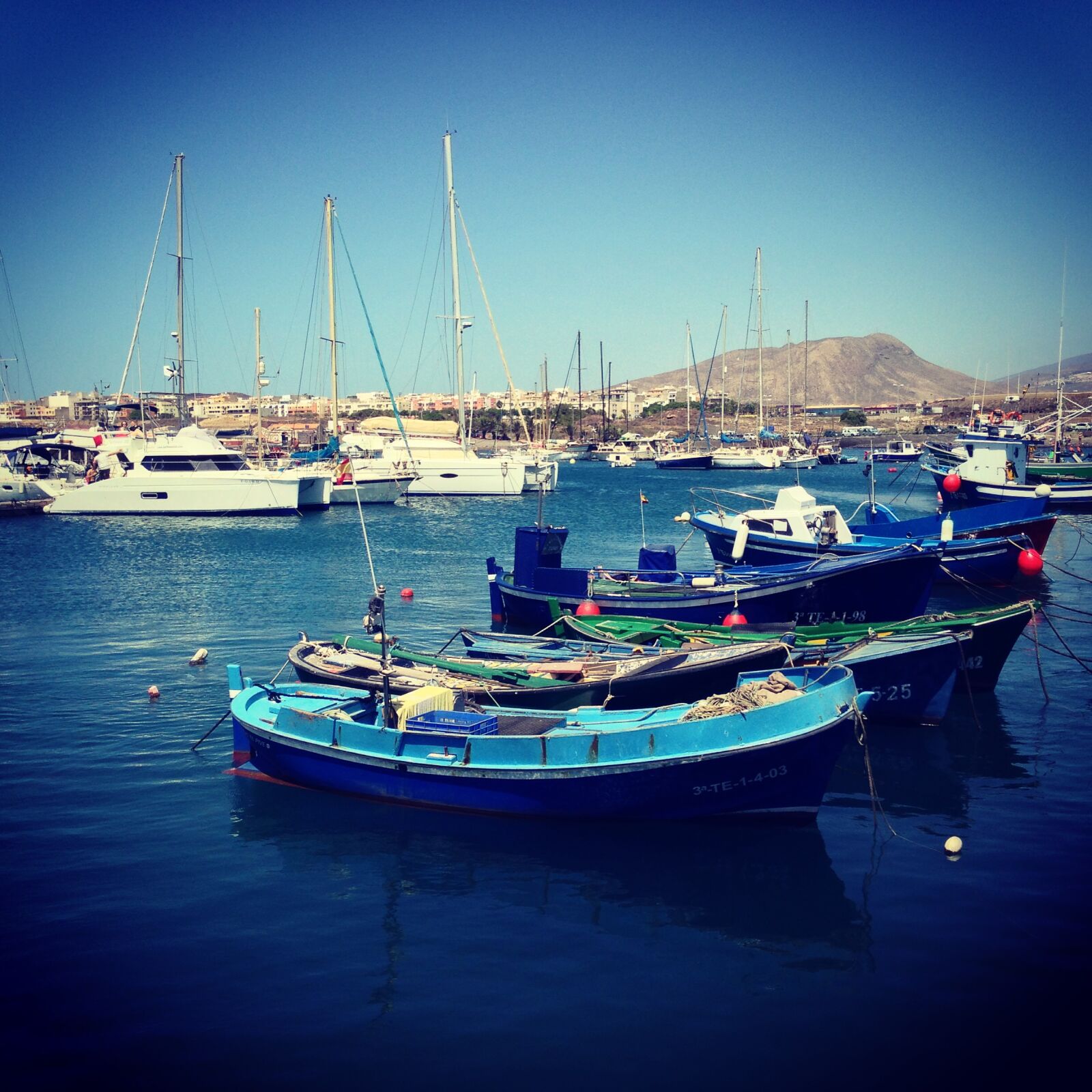 iPhone 5c back camera 4.12mm f/2.4 sample photo. Blue, sky, boats, harbour photography