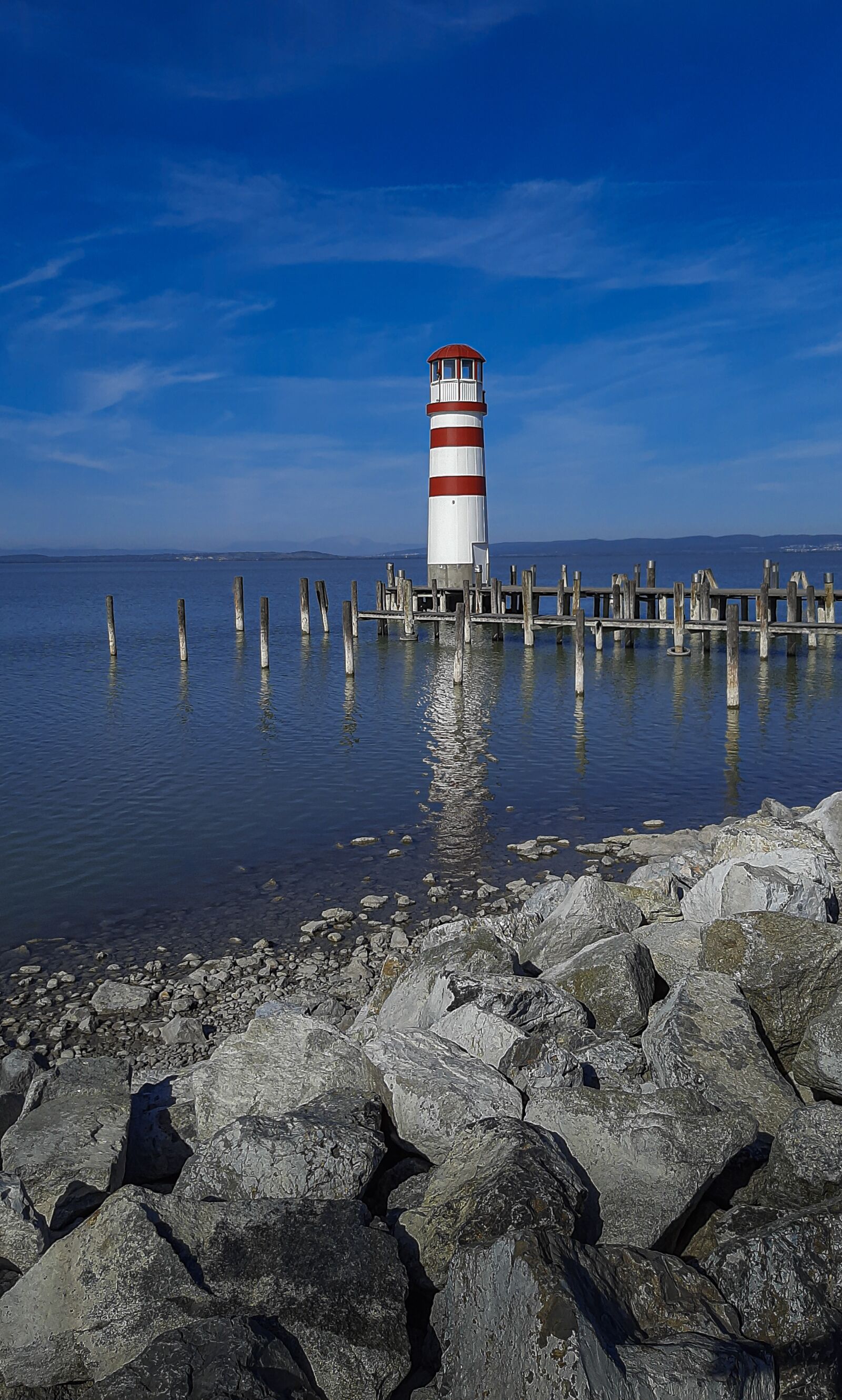 Samsung SM-A307FN sample photo. Lake, lighthouse, stones photography