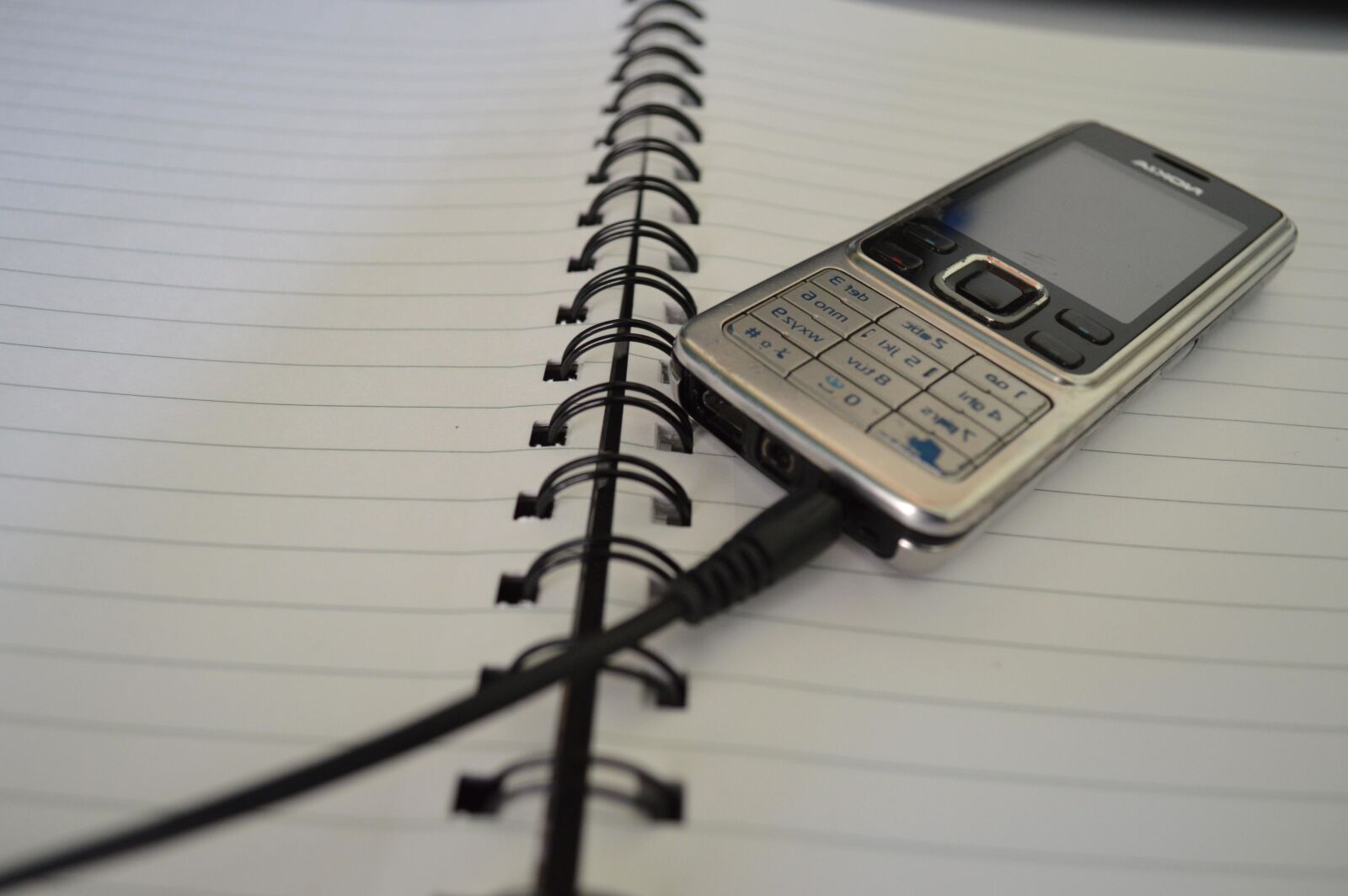 Nikon D3200 sample photo. Book, spiral, mobile phone photography