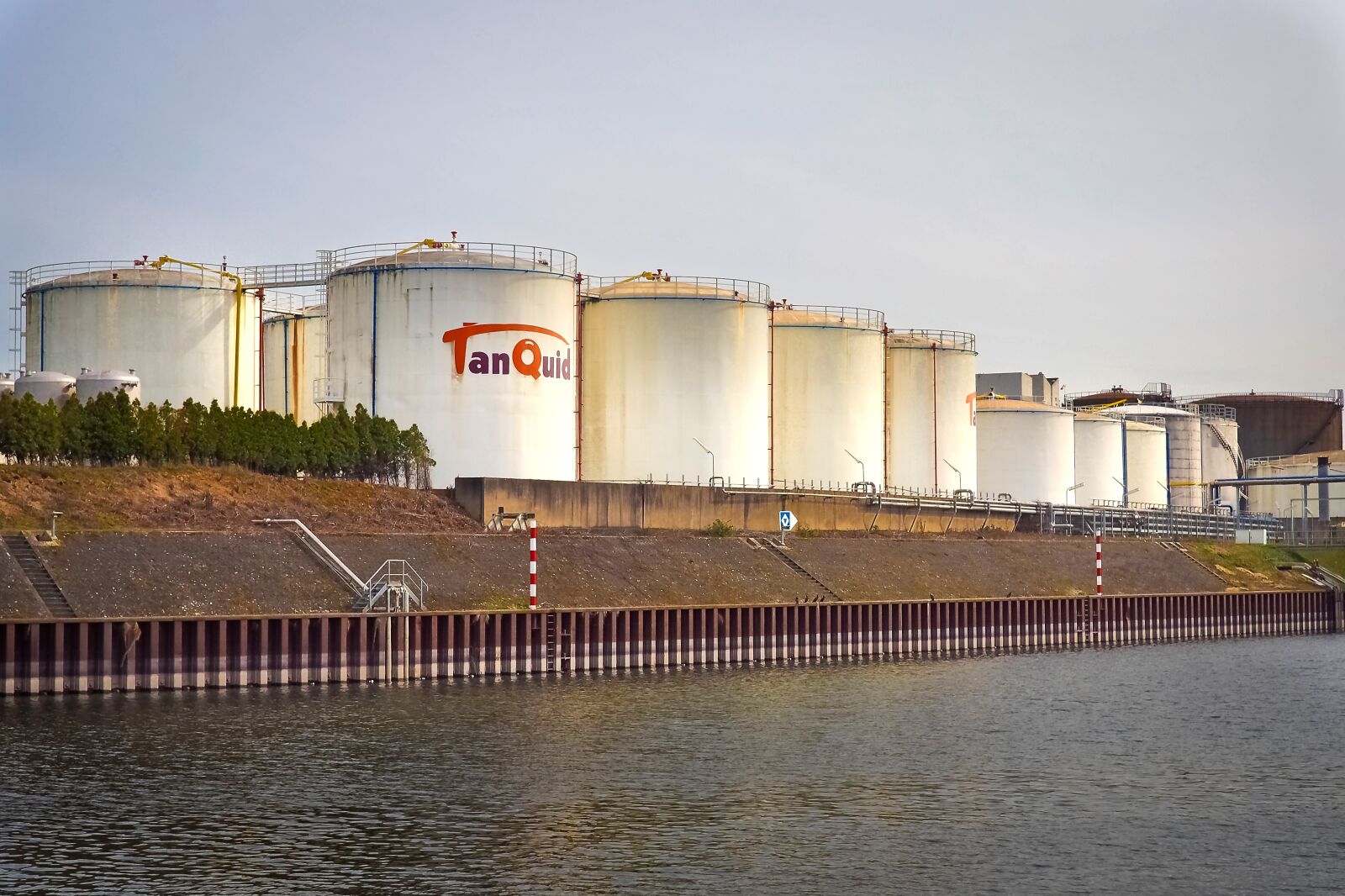 Olympus OM-D E-M10 sample photo. Gasoline tanks, port, industry photography