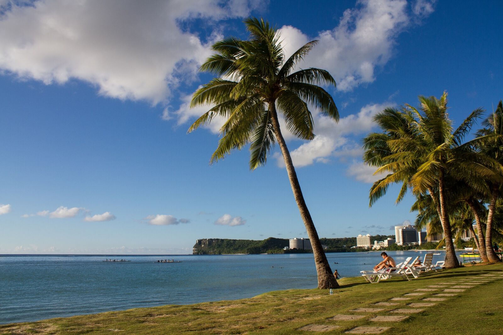 Canon EF-S 18-55mm F3.5-5.6 IS sample photo. Palm trees, ocean, tourists photography