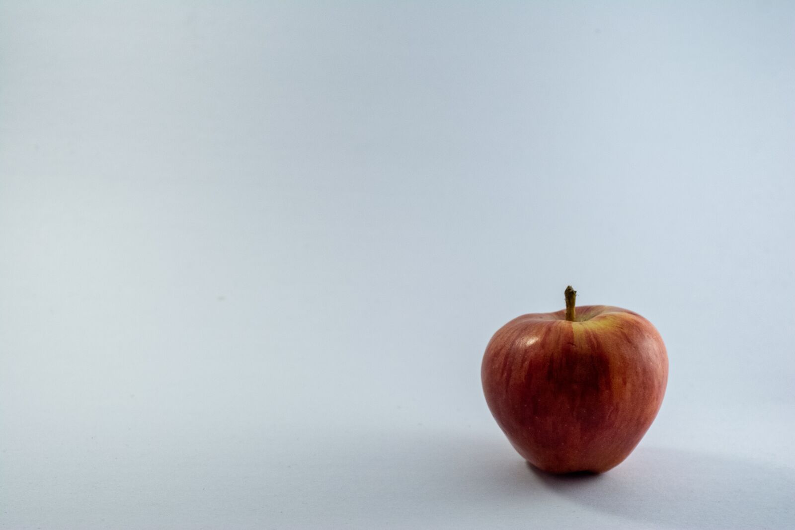 Nikon D5200 sample photo. White background, apple, red photography