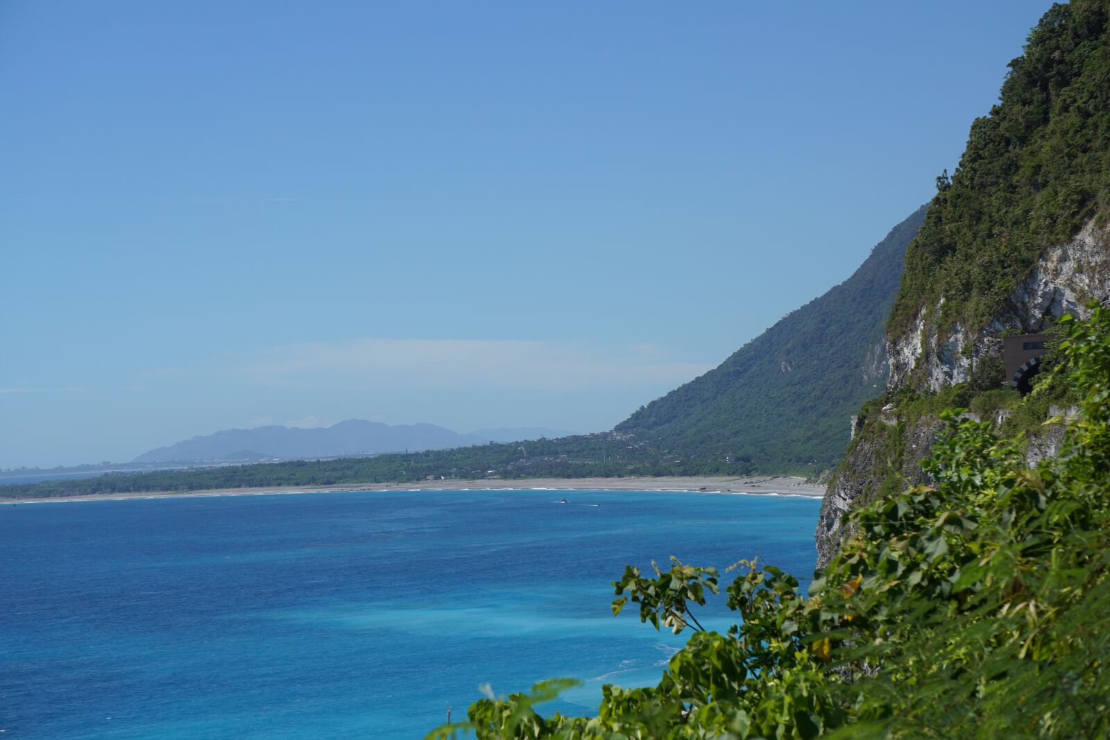 Sony E 55-210mm F4.5-6.3 OSS sample photo. Ocean, mountain, green photography