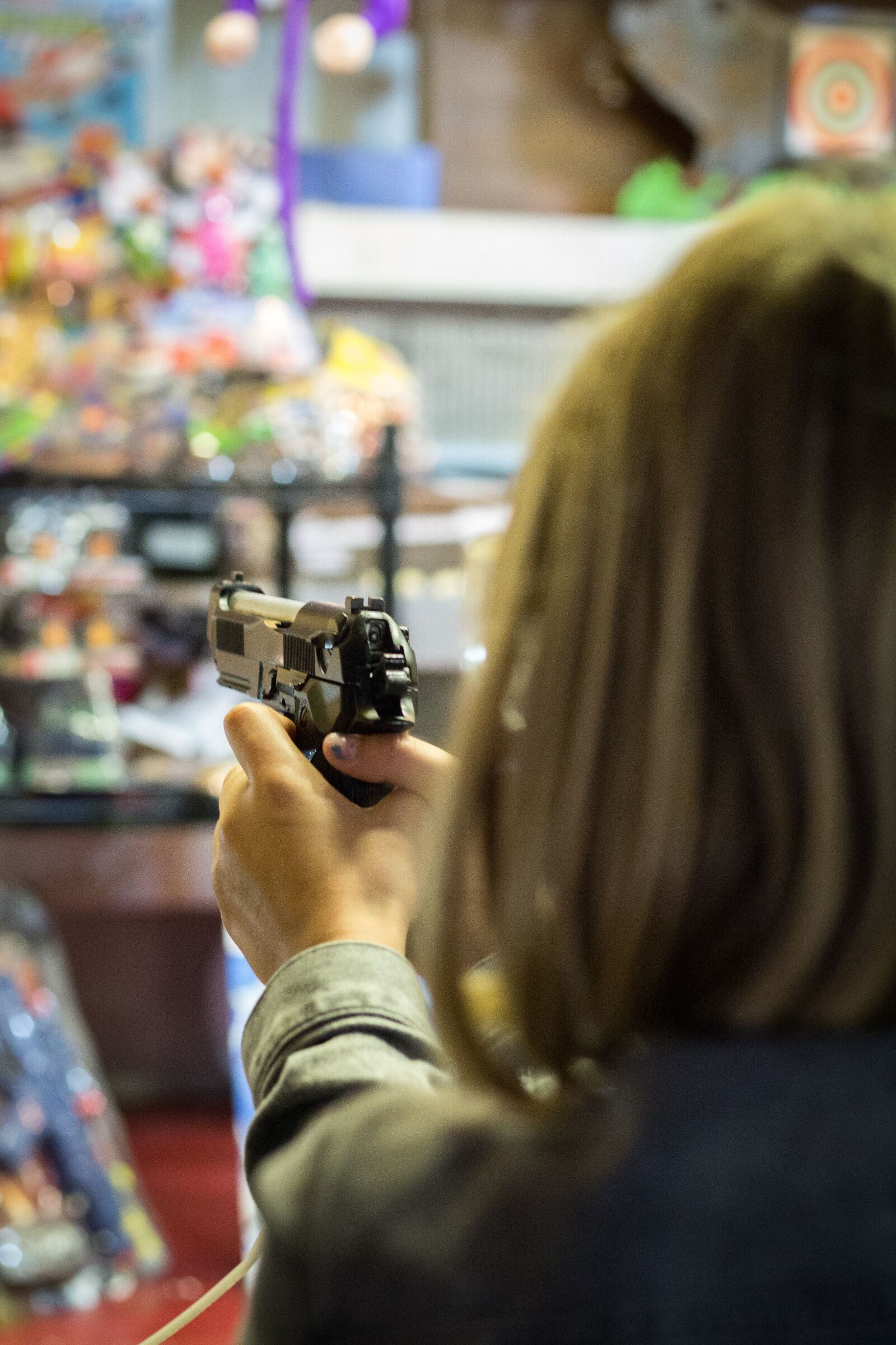 Canon EOS 700D (EOS Rebel T5i / EOS Kiss X7i) + Canon EF 50mm F1.8 II sample photo. Woman, gun, pistol photography