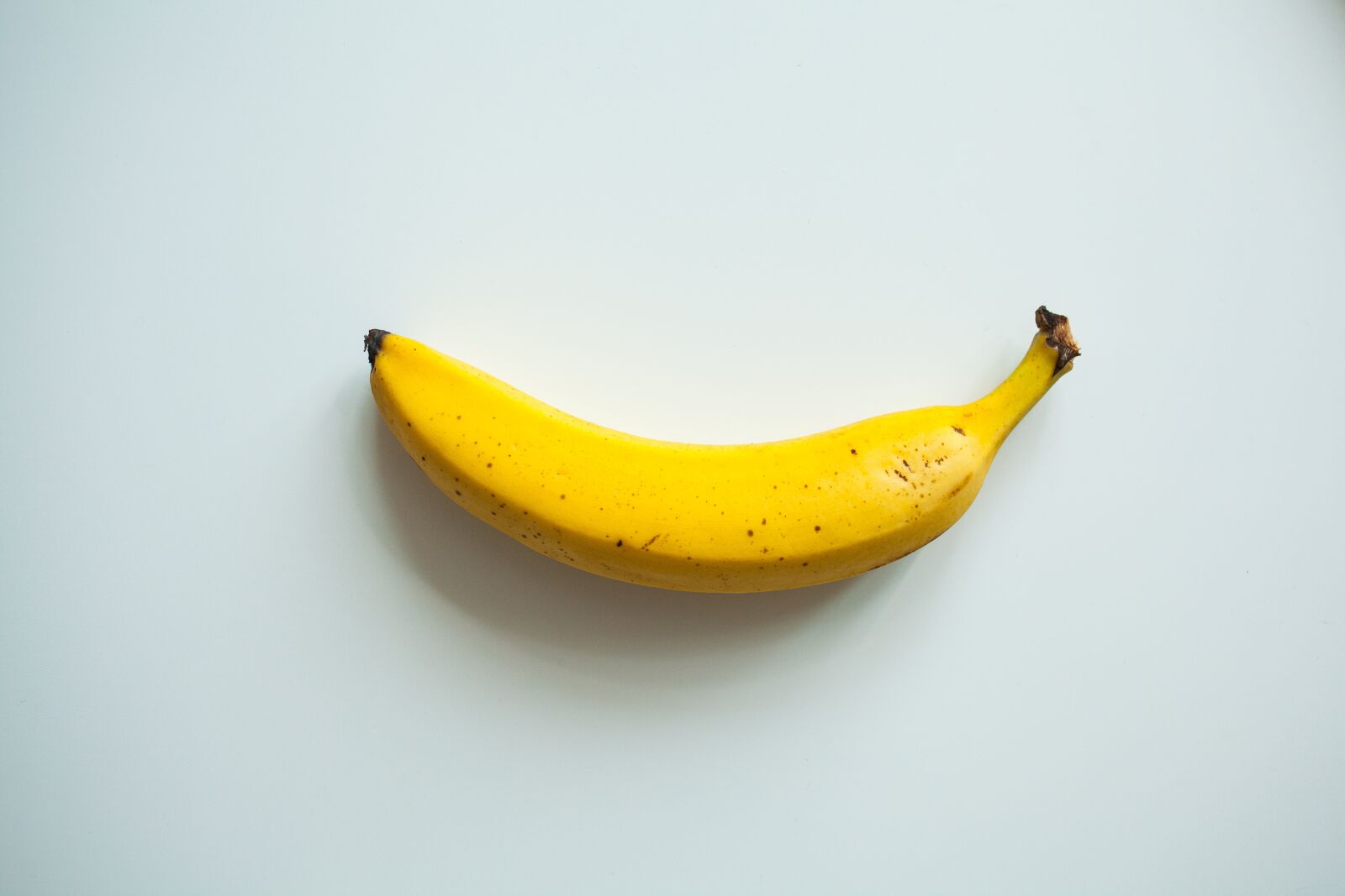 Canon EF 35mm F2 sample photo. Banana, yellow, white background photography