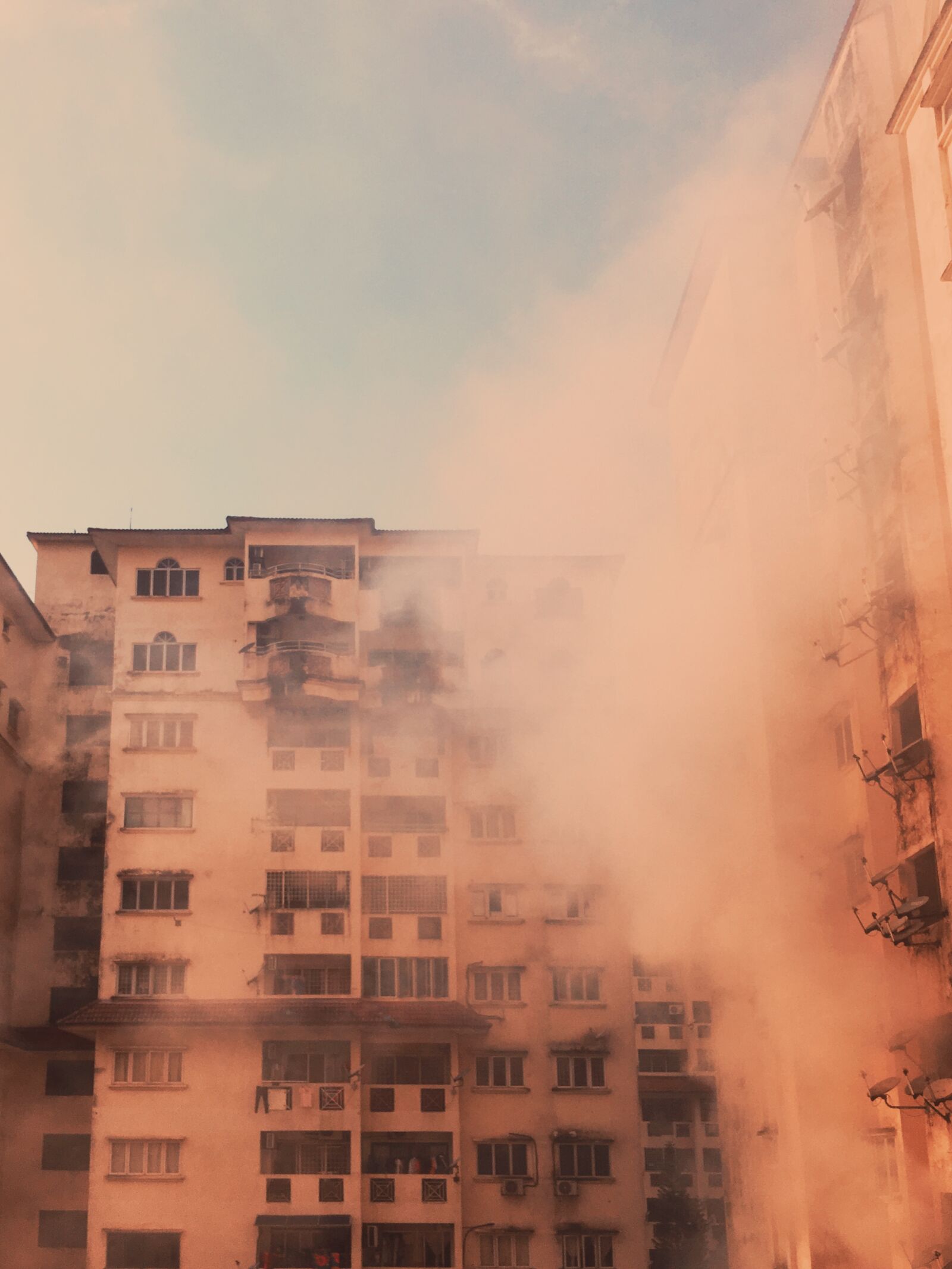 Apple iPhone 6s sample photo. Smoke, buildings, pink photography