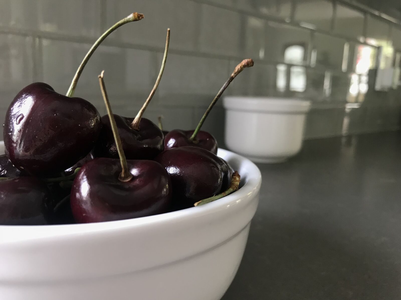 iPhone 7 Plus back dual camera 3.99mm f/1.8 sample photo. Cherries, gray tiles, white photography