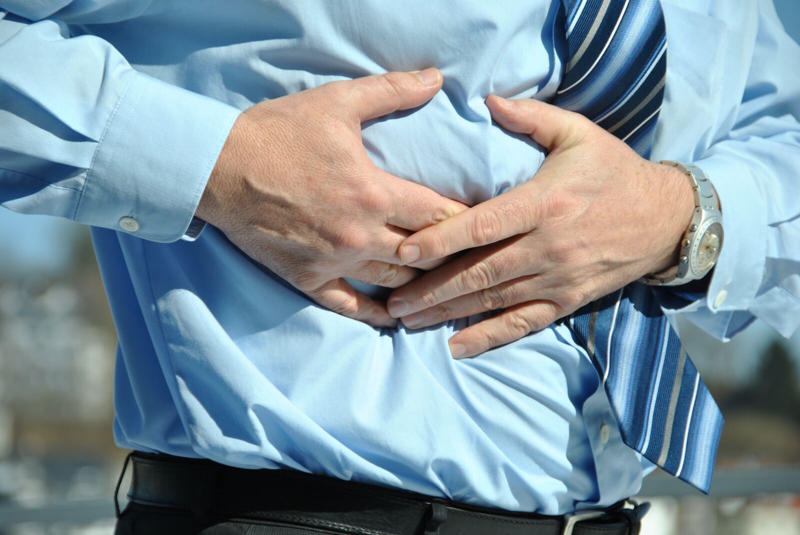Nikon D3000 sample photo. Abdominal pain, attack, medical photography