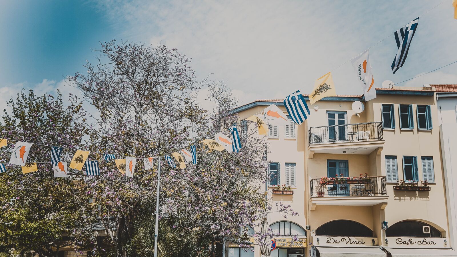 Sony a6000 + Sony Vario-Tessar T* E 16-70mm F4 ZA OSS sample photo. Cyprus, house, flags photography