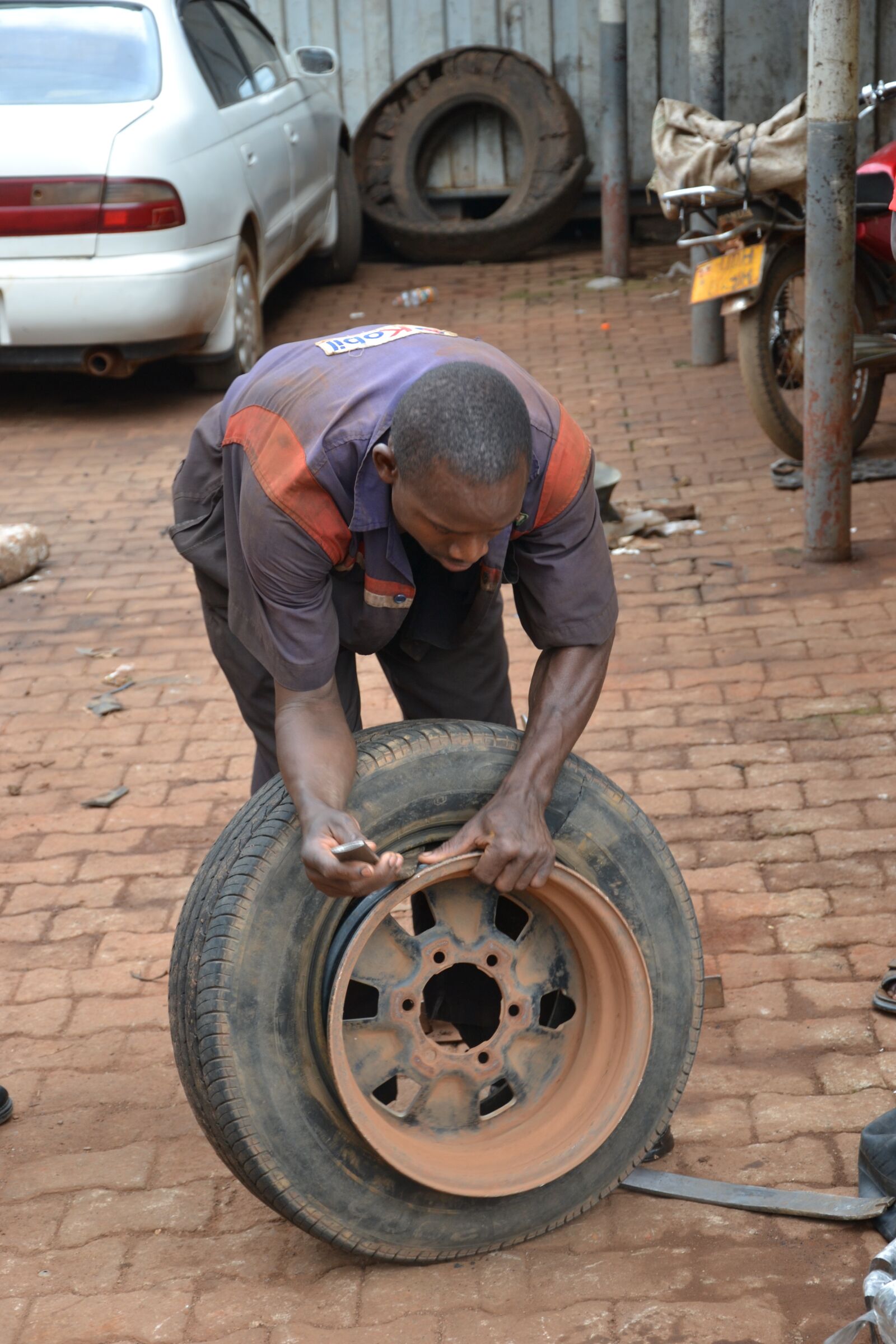 Nikon D3100 sample photo. Flat tire, uganda, car photography