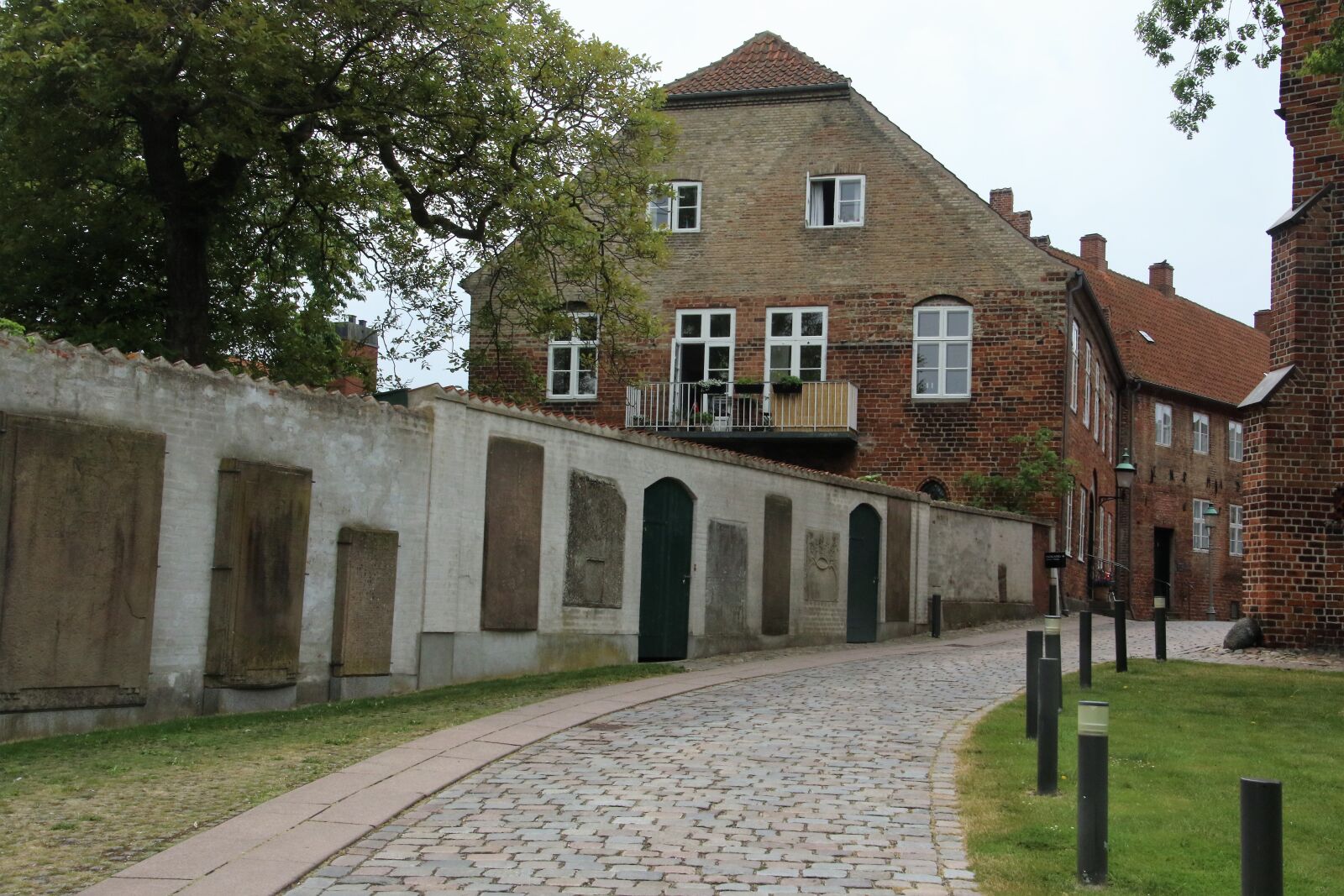 Canon EOS 7D Mark II sample photo. Church, cobblestone, street, graves photography