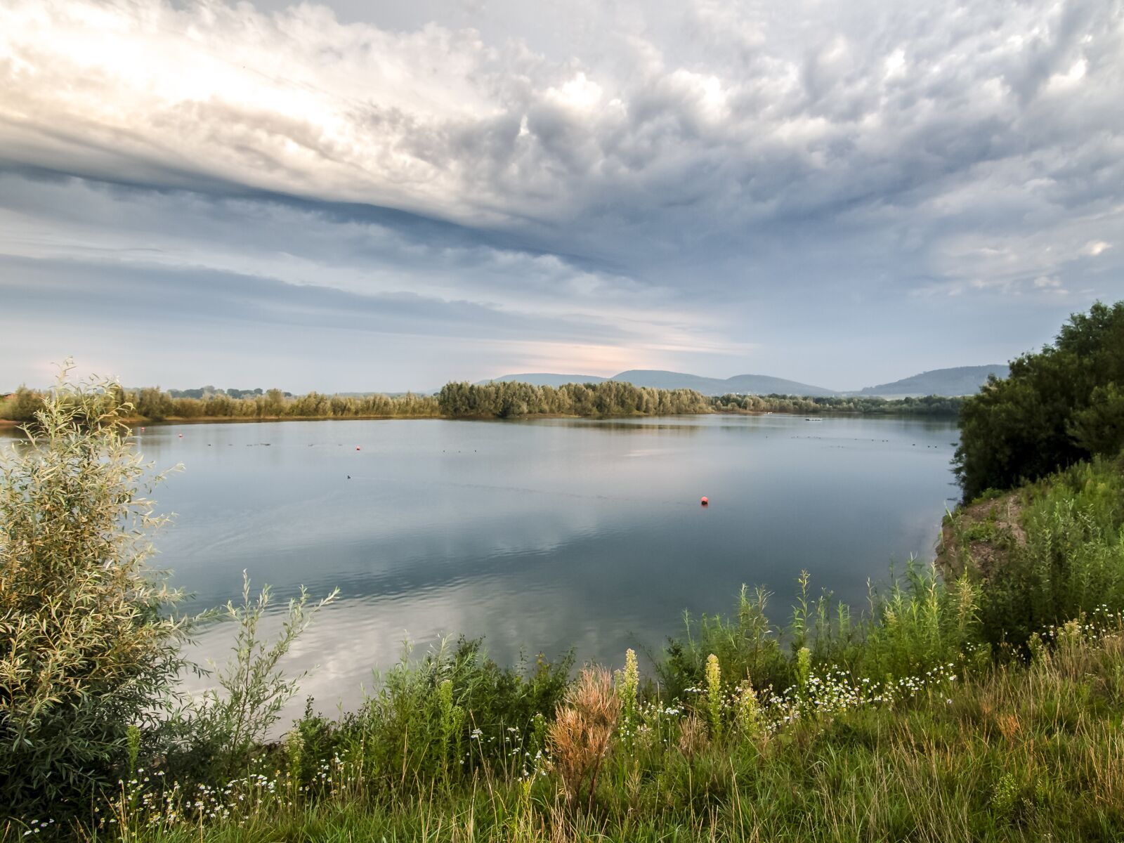 OLYMPUS 11-22mm Lens sample photo. Gravel pond, pond, water photography