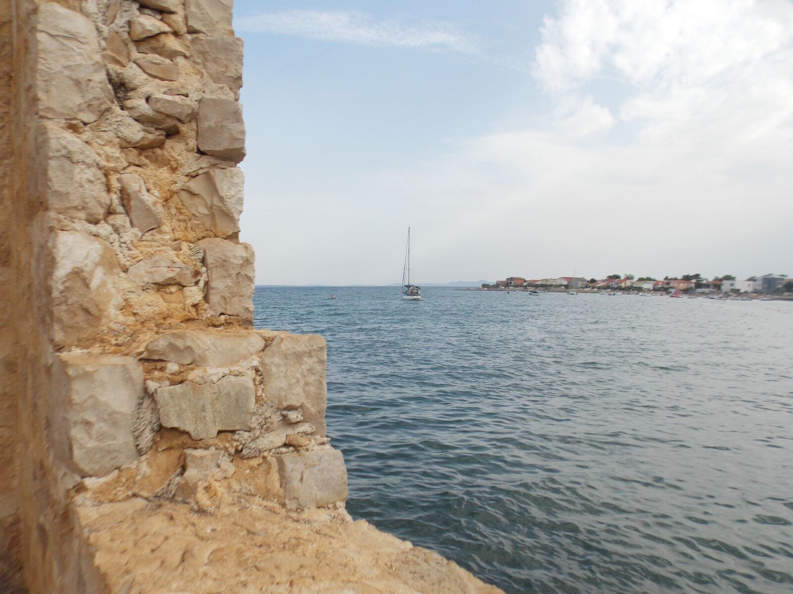 Nikon Coolpix L810 sample photo. Stone wall, sea, blue photography