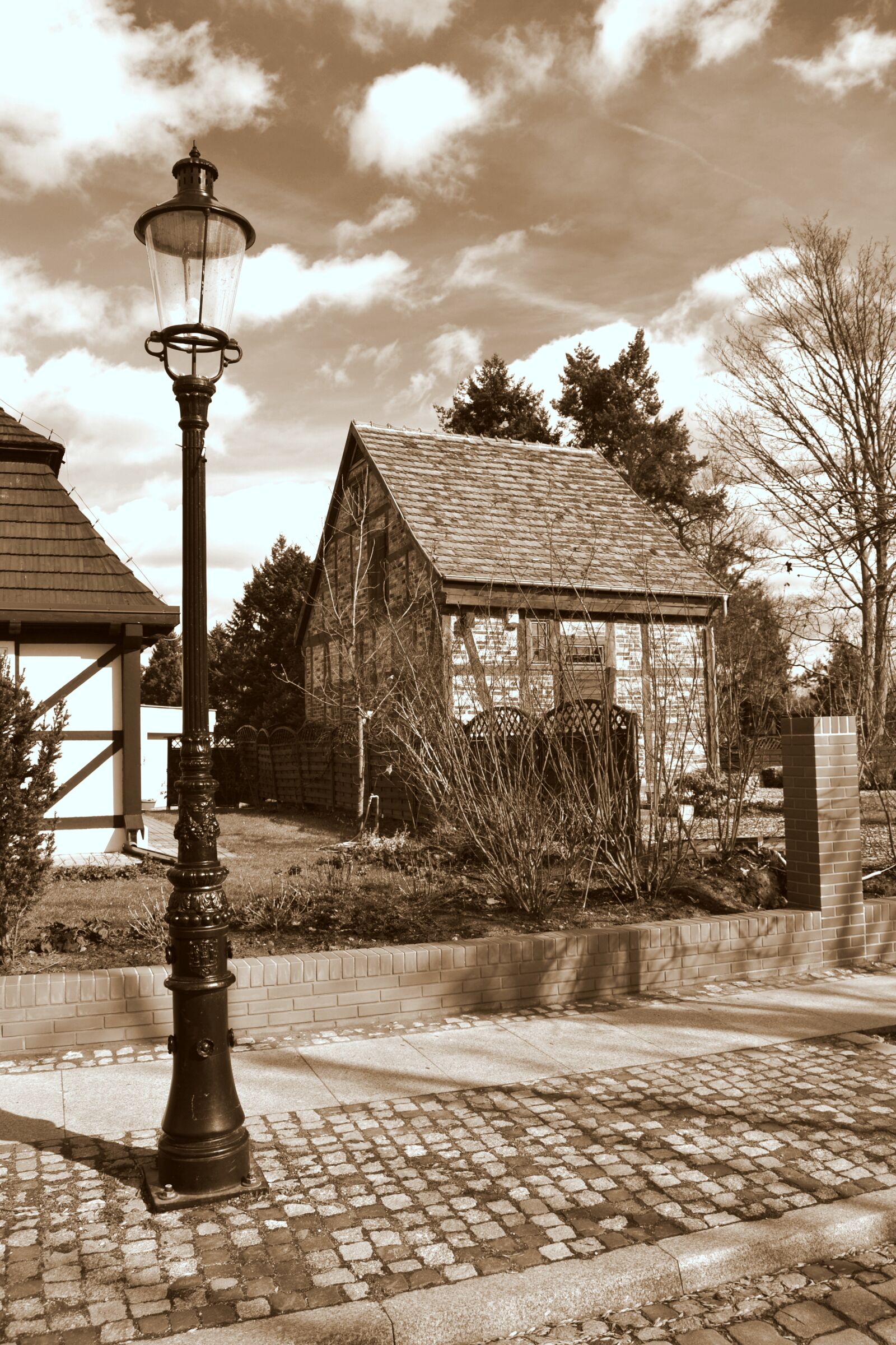 Nikon D3100 sample photo. Sepia, lantern, street photography