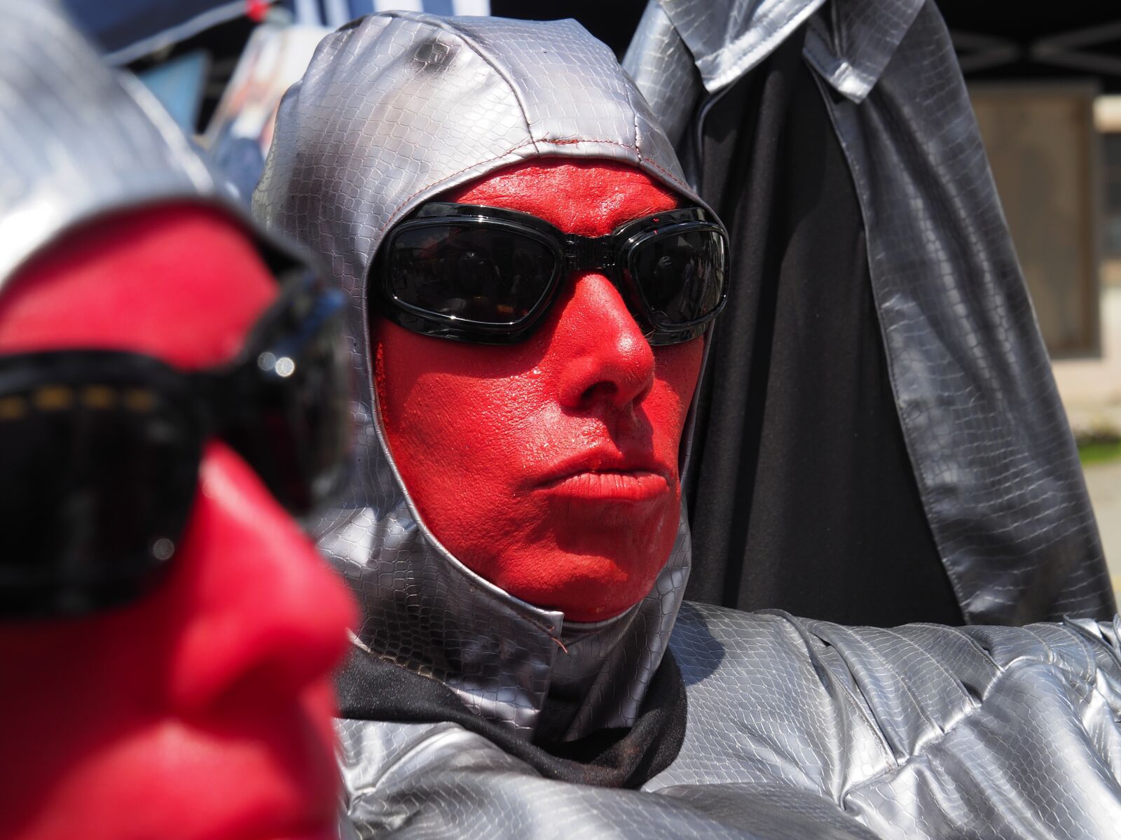 Olympus OM-D E-M10 II sample photo. Street performers, red, face photography