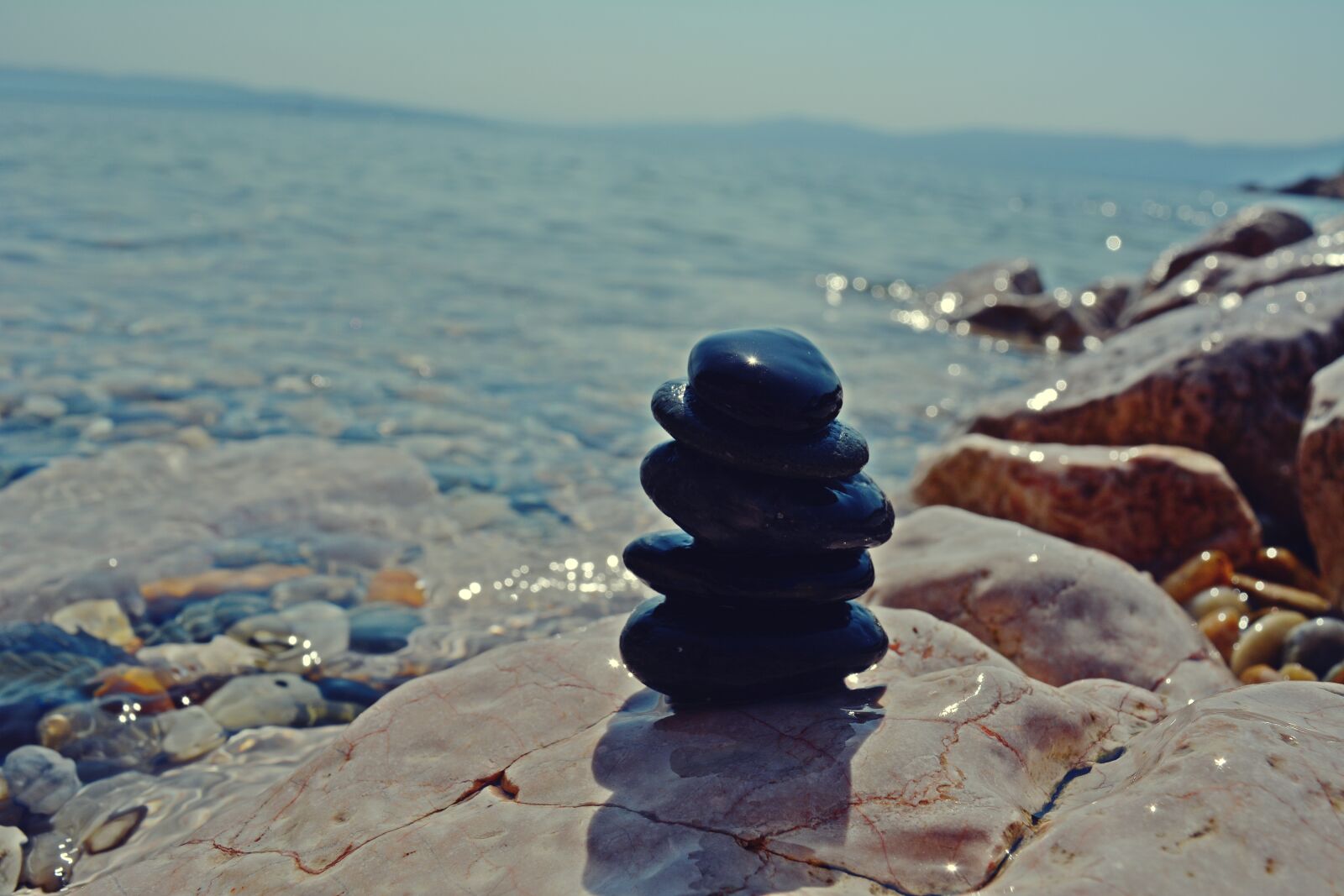 Nikon D5200 sample photo. Stone pile, ocean, beach photography