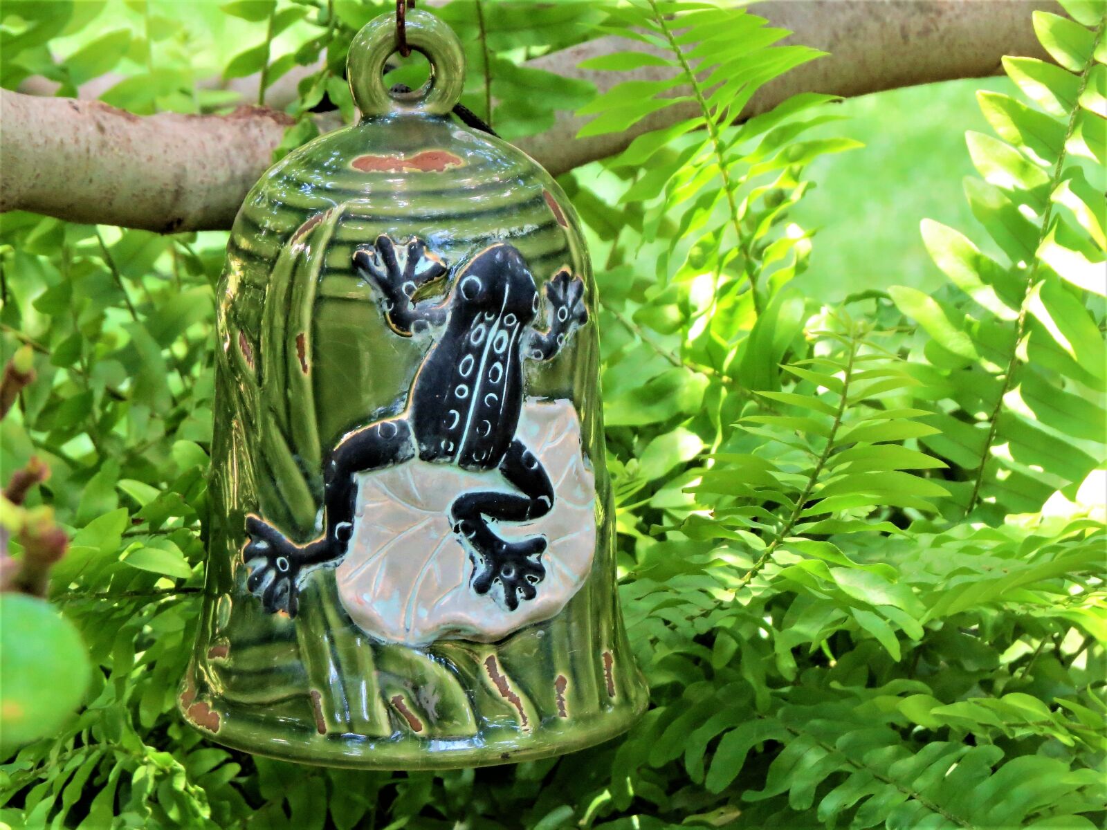 Canon PowerShot SX50 HS sample photo. Ceramic bell, green, yard photography