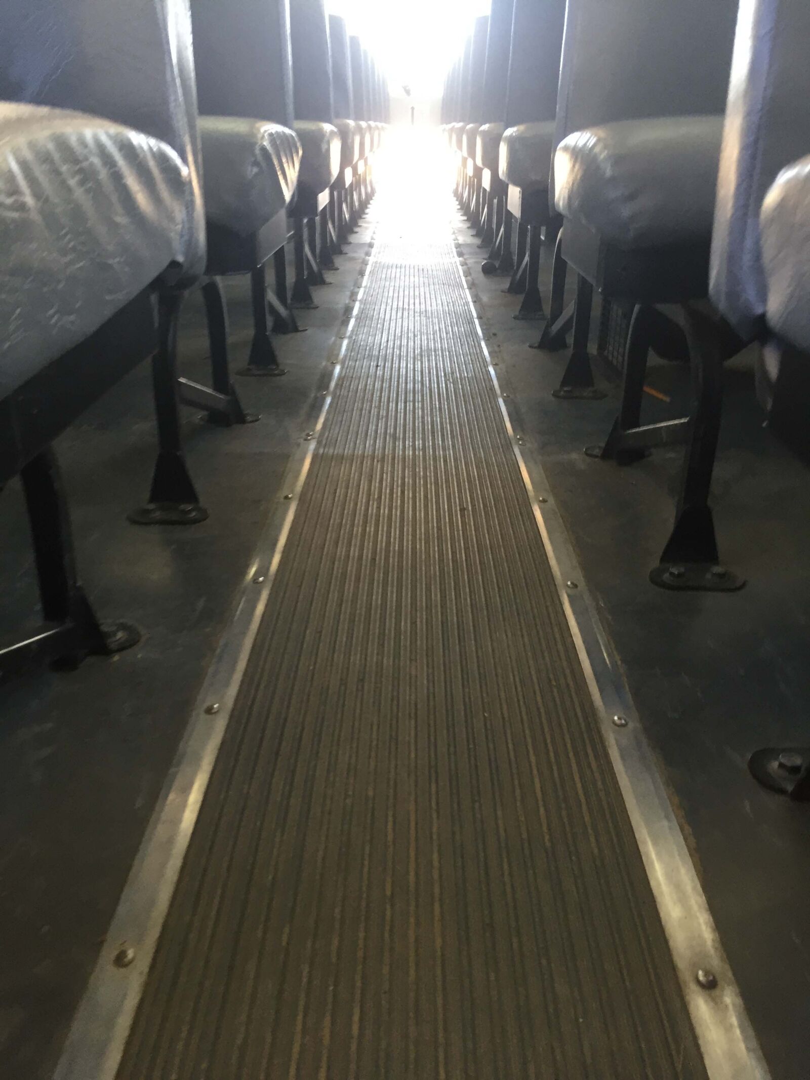 iPhone 6 back camera 4.15mm f/2.2 sample photo. Aisle, backlight, bus, low photography