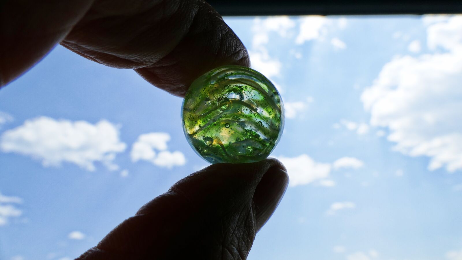 Panasonic Lumix DMC-FZ1000 sample photo. Ball, finger, sky photography
