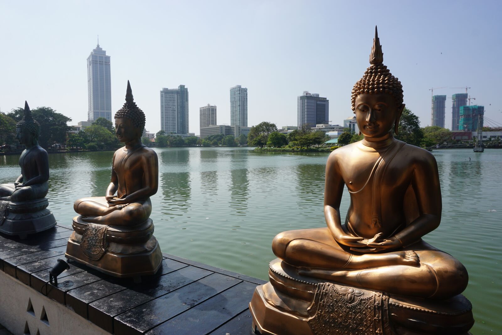 Sony a6000 sample photo. Statues, buddha, skyscrapers photography