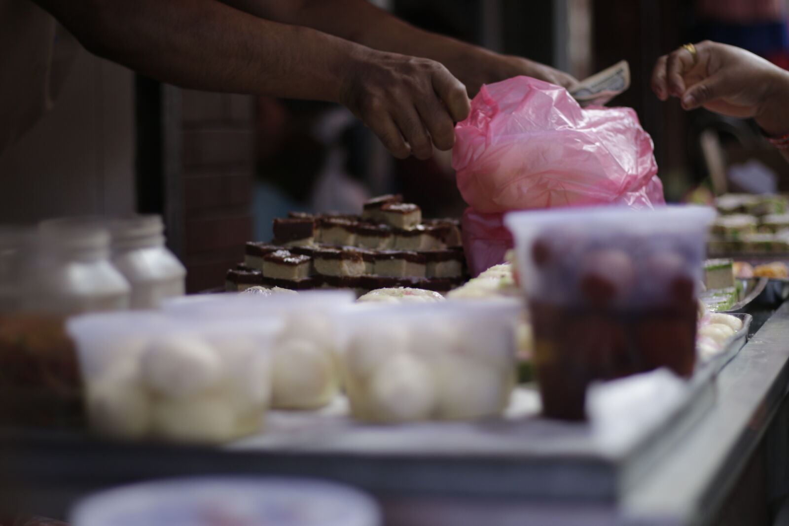 Canon EOS 70D + Canon EF 50mm F1.8 STM sample photo. Busy, merchant, nepal, sweets photography