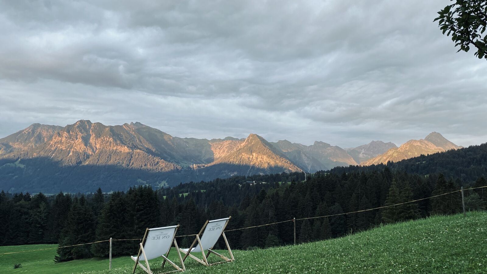 iPhone 11 Pro back triple camera 4.25mm f/1.8 sample photo. Mountains, meadow, deck chair photography