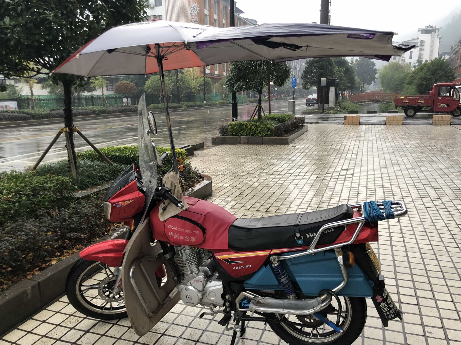 iPhone X back dual camera 4mm f/1.8 sample photo. Asia, moped, rain, transport photography