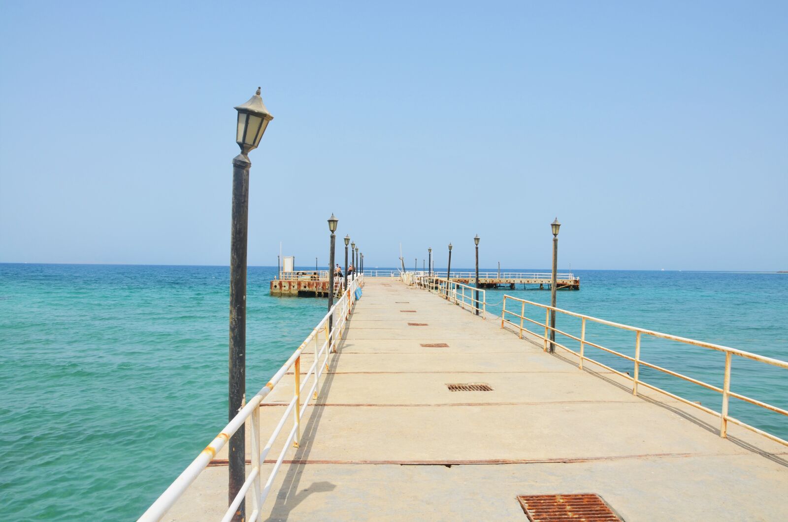Nikon D5100 sample photo. Pier, lamps, ocean photography