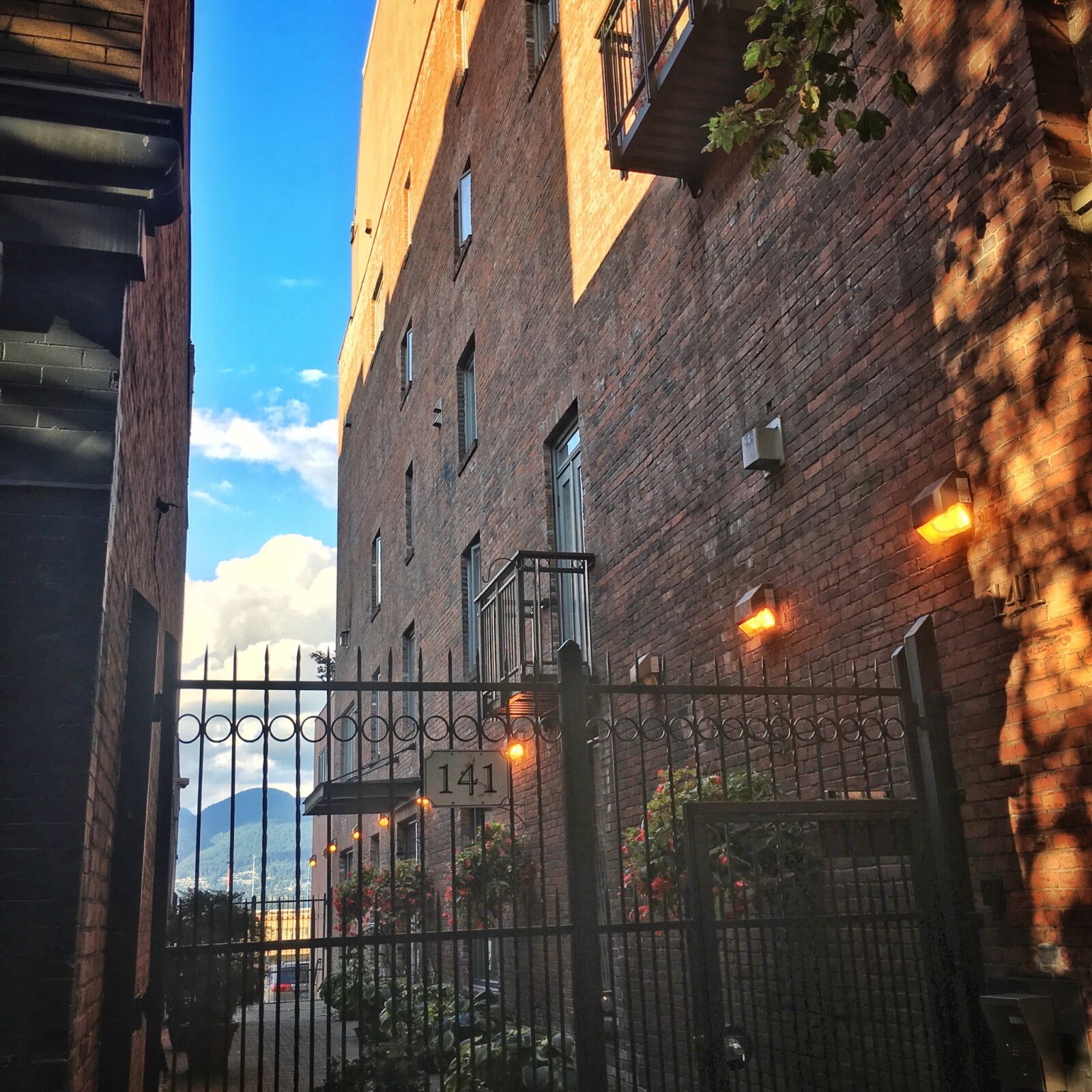 Apple iPhone 6s Plus sample photo. Alley, brick, wall, cloud photography