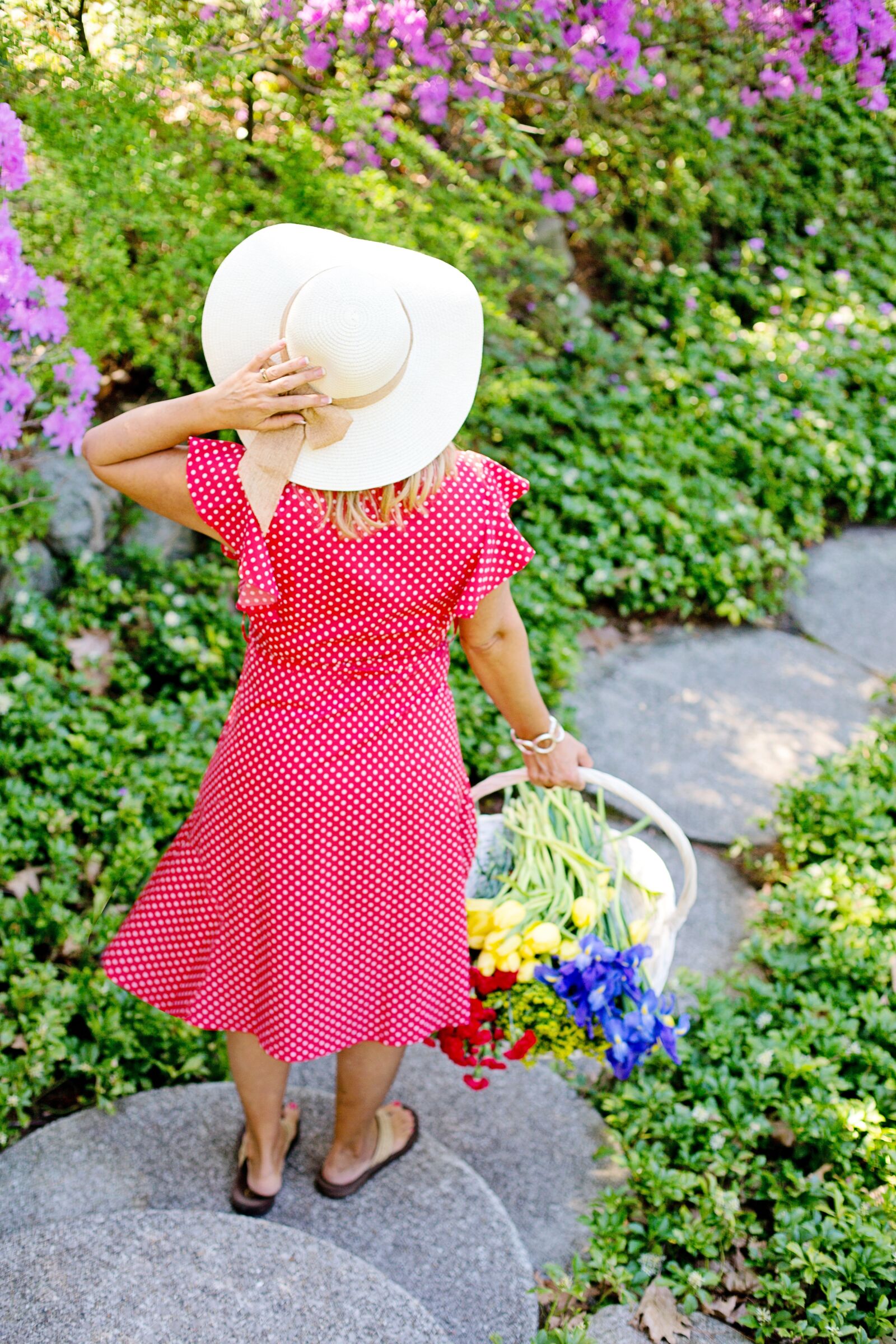 Canon EF 50mm F1.4 USM sample photo. Garden, flowers, woman walking photography