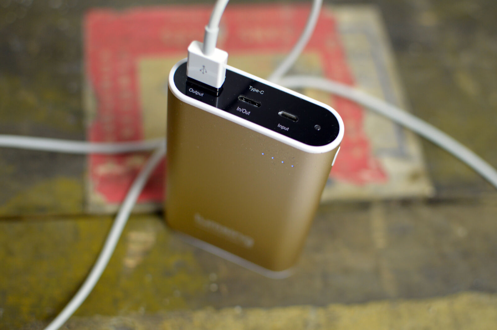 Nikon D3200 + Nikon AF-S DX Nikkor 35mm F1.8G sample photo. Battery, bronze, cable, charger photography