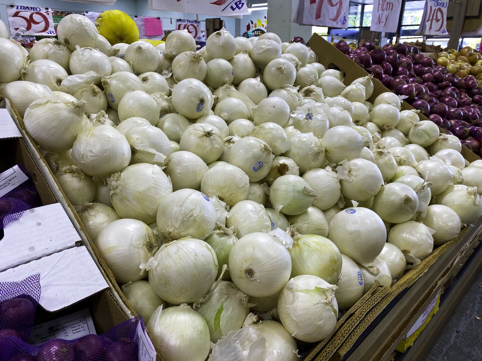 iPhone 11 Pro back triple camera 4.25mm f/1.8 sample photo. Onions, store, grocery photography