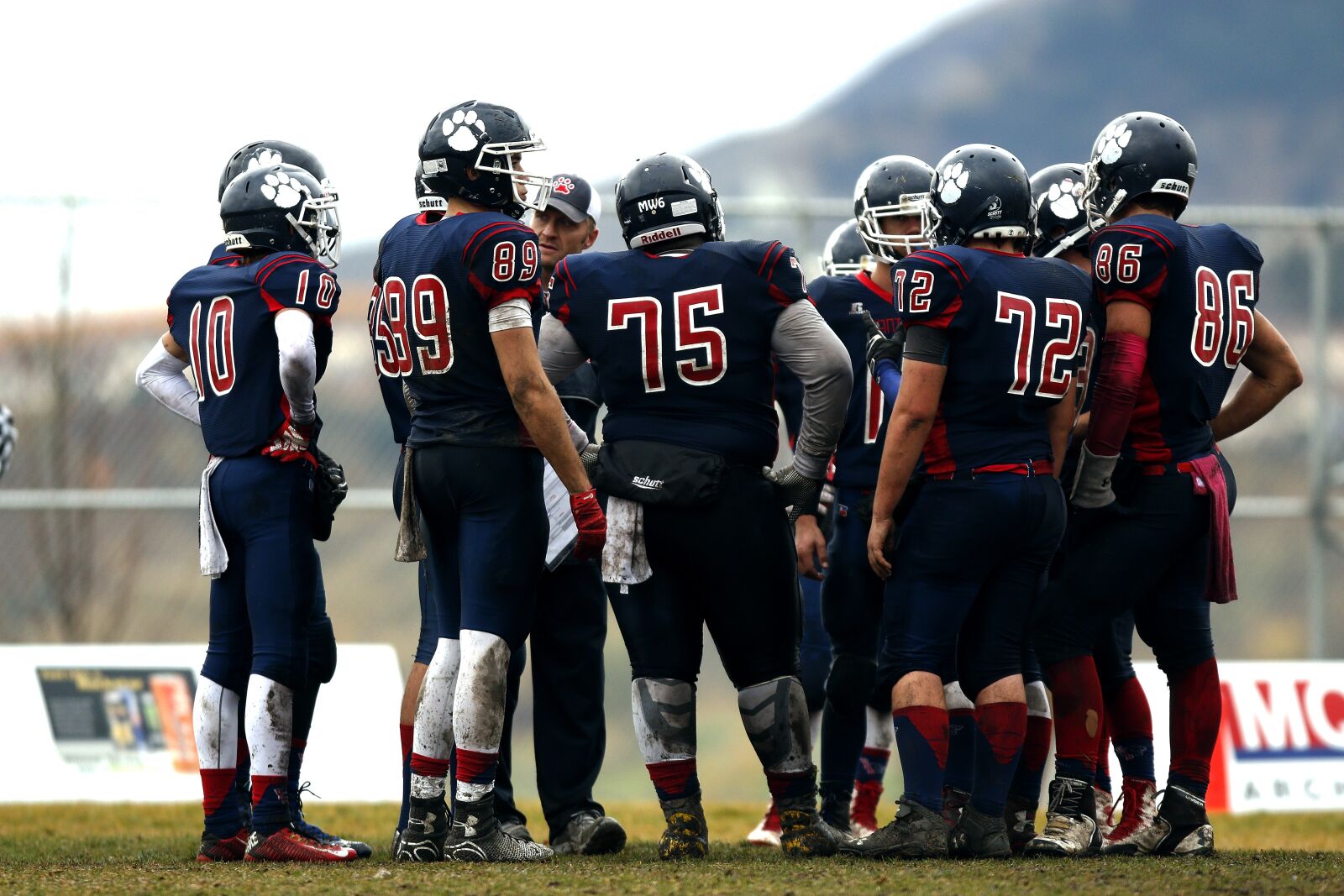 Canon EF 300mm F2.8L IS USM sample photo. Football team, huddle, teamwork photography