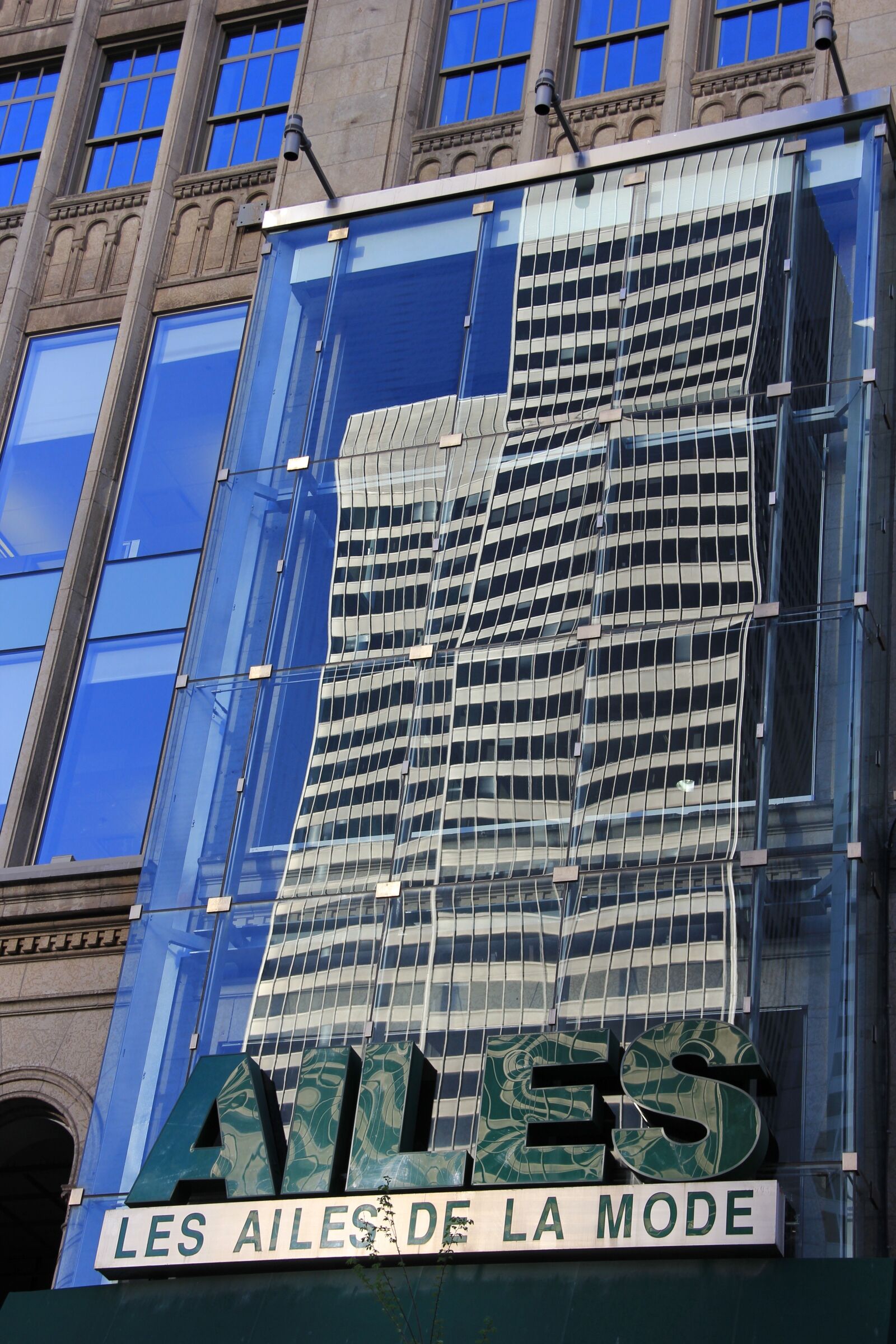 Canon EF-S 18-135mm F3.5-5.6 IS sample photo. Reflection, buildings, lights photography