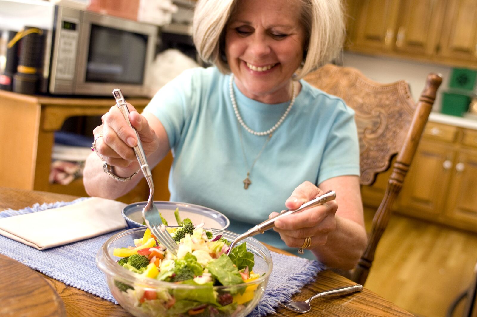 Nikon D300 sample photo. Happy, woman eating, vegetable photography
