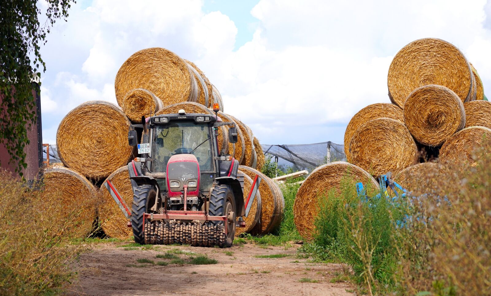 Sony E 70-350mm F4.5-6.3 G OSS sample photo. Tractor, hay bales, agriculture photography