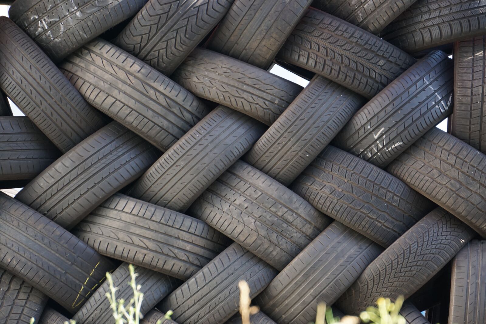 Sony E 55-210mm F4.5-6.3 OSS sample photo. Auto tires, black, stacked photography