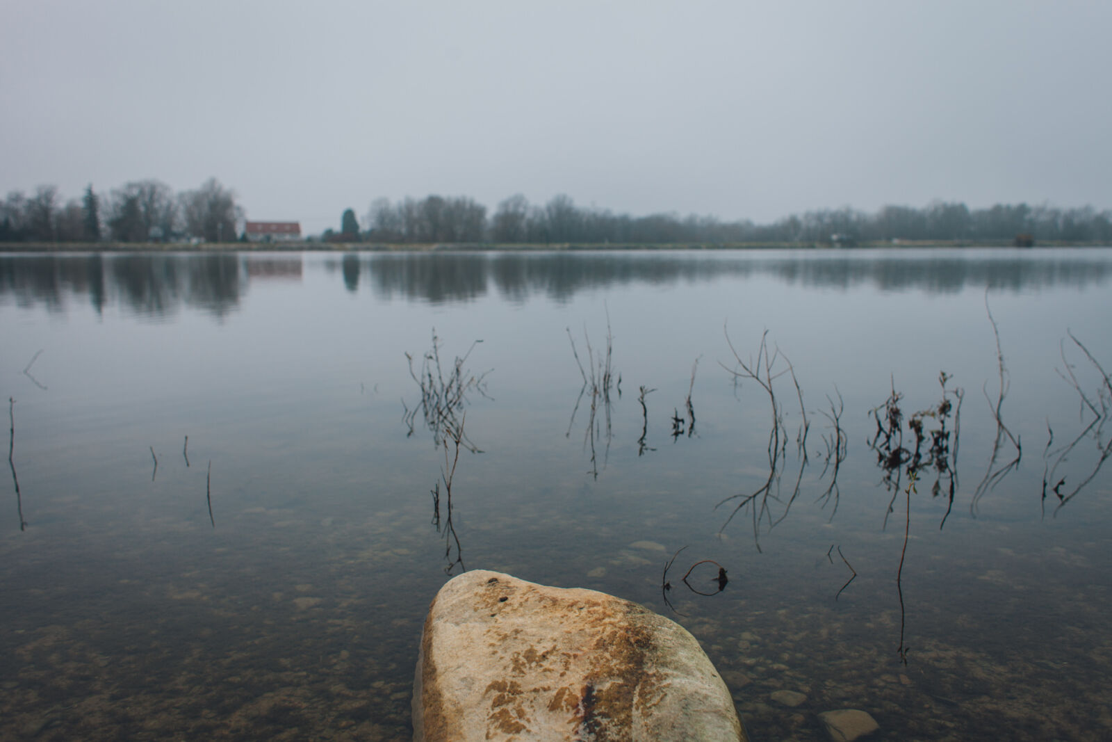 Canon EF 28mm F1.8 USM sample photo. Reflection, reservior, rock, trees photography