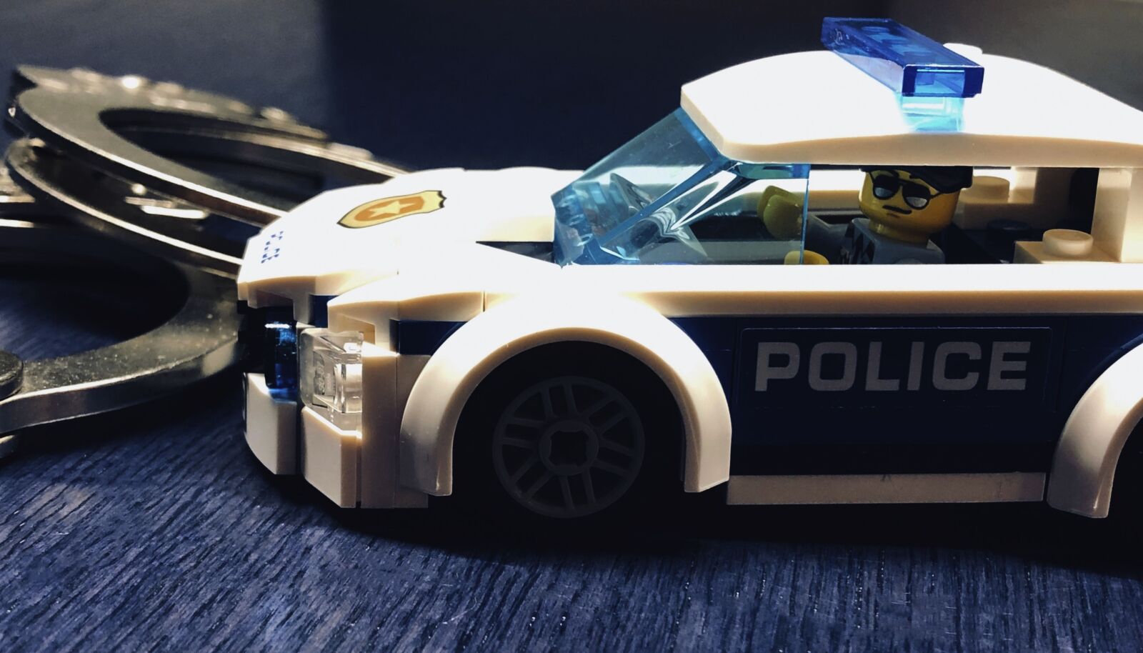iPhone 8 back camera 3.99mm f/1.8 sample photo. Police, police car, miniature photography