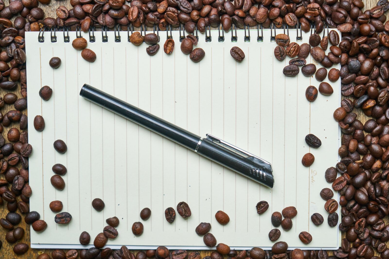 Sony a7R II sample photo. Coffee, notebook, pen photography