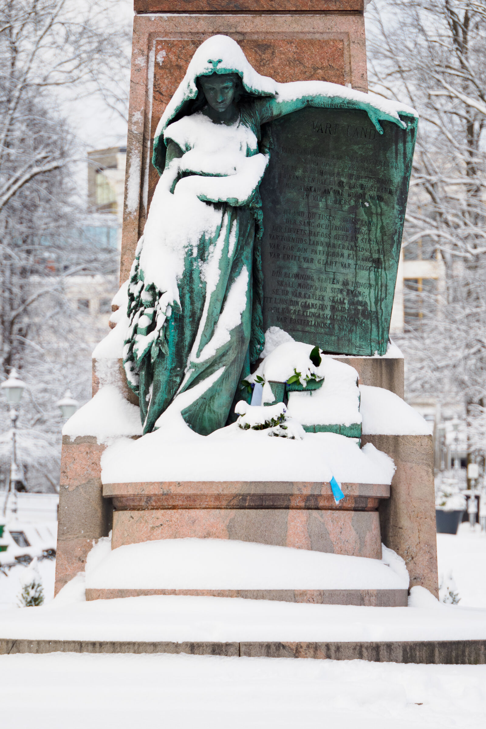 OM System OM-1 sample photo. Statue after snowstorm photography