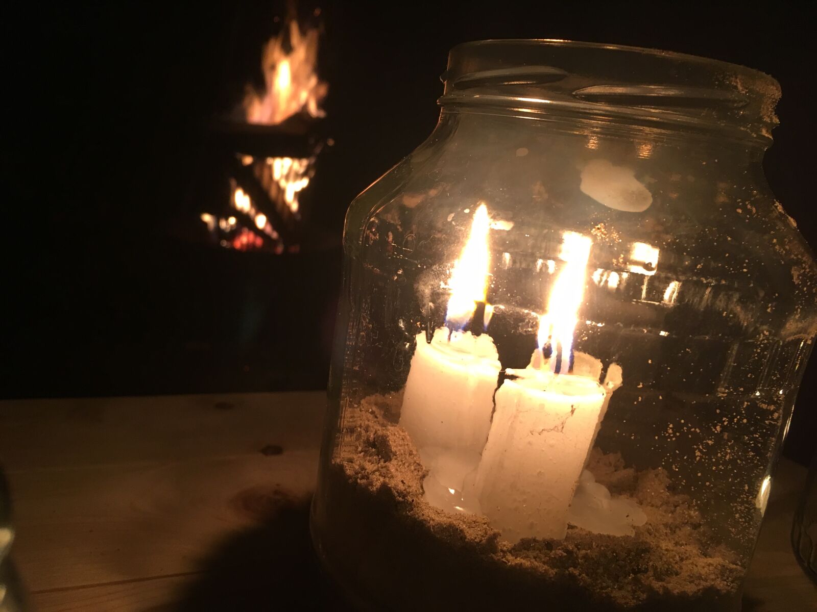 iPhone SE back camera 4.15mm f/2.2 sample photo. Campfire, candles, dark photography