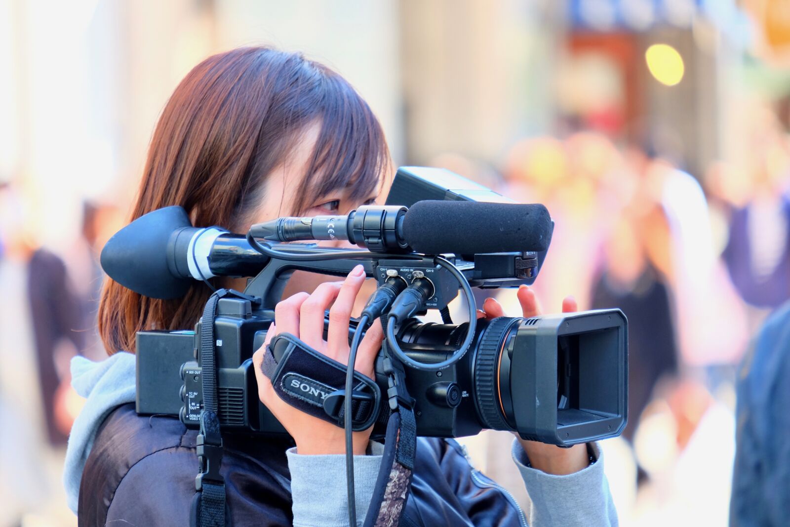 Fujifilm XF 55-200mm F3.5-4.8 R LM OIS sample photo. Female, cameraman, shooting photography