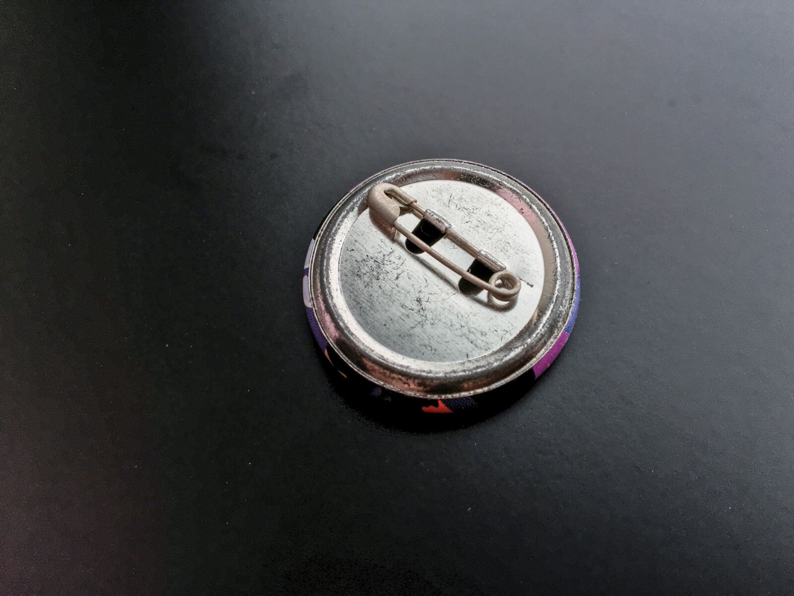 Apple iPhone 6s sample photo. Tin badge, badge, metal photography
